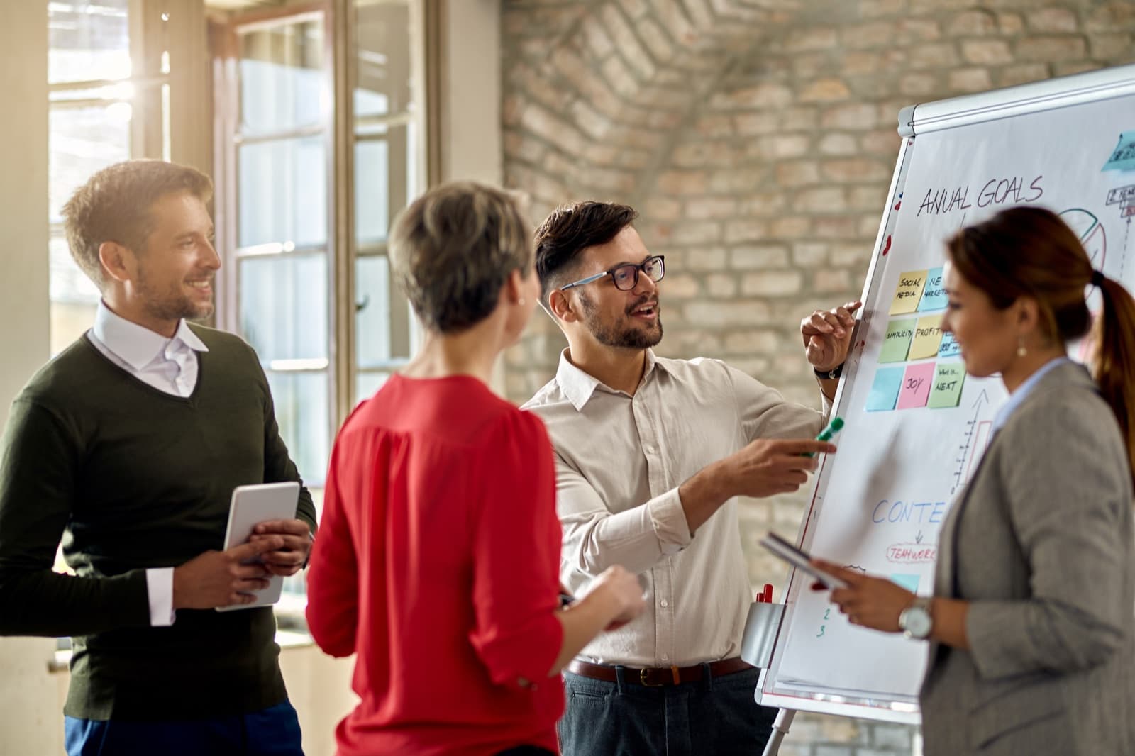 A team planning at a whiteboard in a bright office